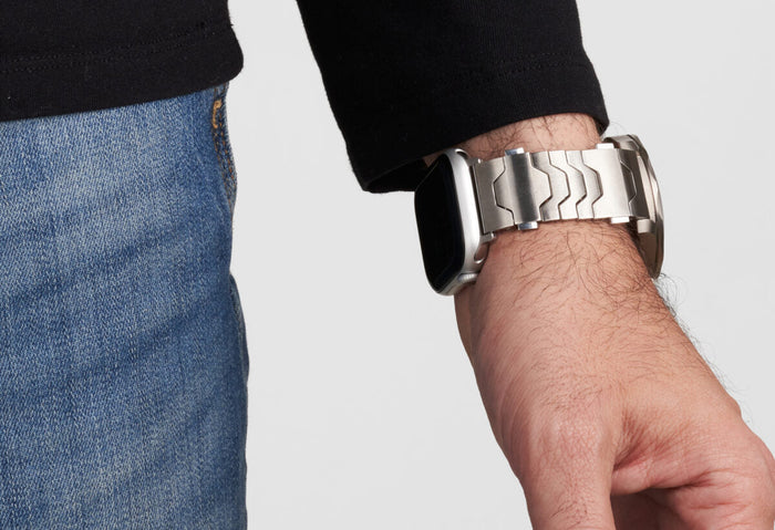 Man wearing Rolex and Apple Watch together at table