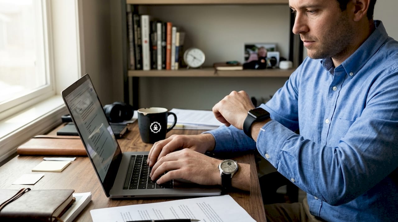 Man wearing mechanical and smartwatch at desk