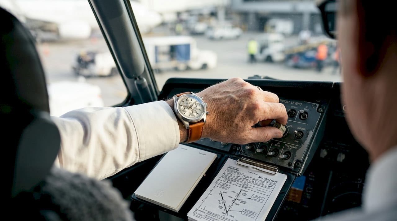 Pilot using mechanical watch in cockpit