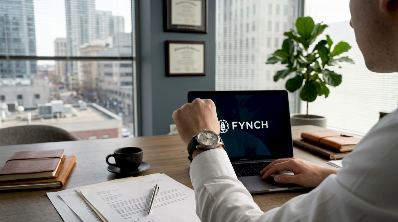 Young professional checks watch in city office